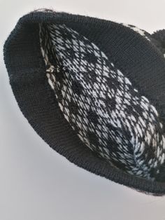 Knitted winter hat. Medium size available appr.56-58 cm head circmference. Traditional small nordic star pattern - dark grey or black variation is available. 100% lambs wool, without lining. Double edge, to keep hat more fit. This hat is unique - unisex model. Very well matching to men. There is used 2 basic colour for white star pattern: main colour is dark grey or black.. The edge has block striped pattern, red stripes included. Medium size - head circumference appr.56-58 cm, length 22 cm. Siz Black Wool Hats For Cold Weather, Black Wool Beanie Cap, Black Wool Beanie For Winter, Black Knitted Beanie For Winter, Black Hand Knitted Beanie One Size, Nordic Warm Beanie For Cold Weather, Warm Nordic Beanie For Cold Weather, Cozy Warm Black Beanie, Black Hand Knitted Beanie Cap