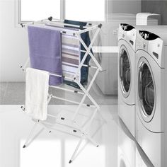 an ironing board next to a washer and dryer