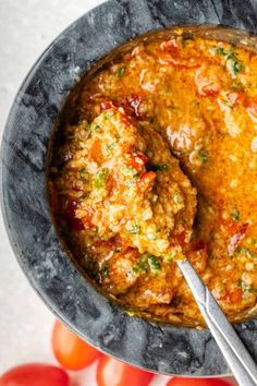 a bowl filled with meatballs covered in tomato sauce