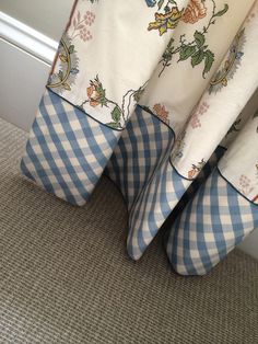 a close up of a bed with blue and white checkered sheets