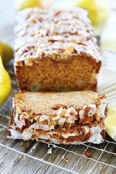 a loaf of banana nut bread sitting on top of a cooling rack next to bananas