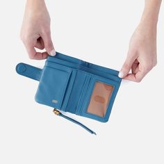 Inspired by our bestselling Fern Crossbody, this compact bifold wallet has room for your cards and cash and a leather zipper pull. Fern Bifold Wallet in Pebbled Leather  Dusty Blue MINI WALLET in Blue | Hobo® Cheap Blue Coin Purse With Card Slots, Affordable Blue Coin Purse With Zipper Closure, Cheap Blue Portable Coin Purse, Cheap Portable Blue Coin Purse, Cheap Blue Coin Purse For Travel, Blue Shoulder Bag With Card Slots, Cheap Blue Trifold Wallet With Coin Pocket, Cute Cheap Blue Wallets, Cheap Blue Wallets With Zipper Pouch