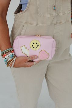 So cute! Take your boho style to the next level with the adorable Smile In Style Pouch—the perfect accessory for any occasion! Convenient pouch style bag with eye-catching details Faux leather material with so CUTE Smiley face, lightning bolt and heart patch designs Convenient zipper pouch closure *Due to lighting and differences in monitors, actual colors may vary slightly from what appears online. Model is 5'8" and wearing a size One Size. Approximate measurements are as follows: ONE SIZE: Len Cute Cosmetic Bag With Removable Pouch, Trendy School Pouch With Removable Feature, Cute Travel Pouch, Trendy Zipper Pouch Cosmetic Bag, Trendy Zipper Pouch, Trendy Removable Pouch As Gift, Trendy Pink Cosmetic Bag For Everyday, Trendy Pink Pouch For Everyday Use, Trendy Pink Everyday Pouch