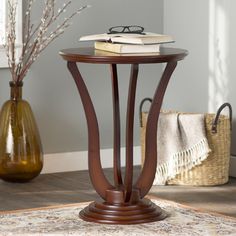 a table with a book on top of it next to a vase filled with flowers