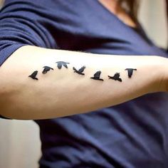 a woman's arm with birds on it and the word love written in black ink