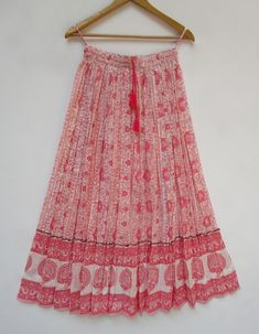 "ITEM DESCRIPTION beautiful baby pink floral printed bohemian style maxi skirts - long screen printed Indian long maxi skirts Material: 100% cotton cambric soft crinkled fabric Length: - 38 inch long Waist :-28.00 inch full (14 inch half) 28 inch relaxed can stretch up to 50 inch Size: free size (fit to all) PRODUCT NAME: - Long Women Maxi skirts Ladies Vintage Long skirts Company Return Policy: Please write for more information to my email directly CHOOSE \"ASK SELLER QUESTION \" payment policy Bohemian White Floral Print Maxi Skirt, Pink Printed Skirt For Summer, Bohemian White Maxi Skirt With Floral Print, Pink Floral Print Flowy Maxi Skirt, Pink Tiered Cotton Maxi Skirt, Bohemian Pink Floral Print Maxi Skirt, Traditional Pink Skirt For Summer, Bohemian Maxi Length Pink Skirt, Bohemian Pink Maxi Skirt