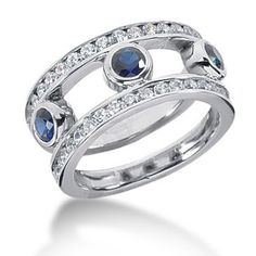 an 18k white gold diamond and blue sapphire ring with round cut diamonds on each side