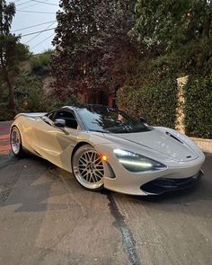 a silver sports car is parked on the street