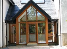 the front entrance to a house with large windows