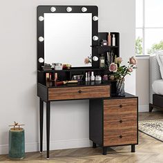 a vanity table with drawers and lights on it