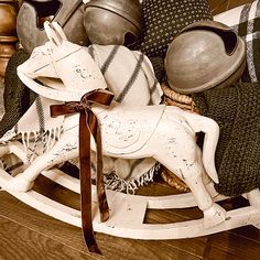 an old rocking horse is sitting on the floor next to other antique items and decor