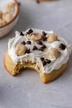 a cookie with white frosting and chocolate chips