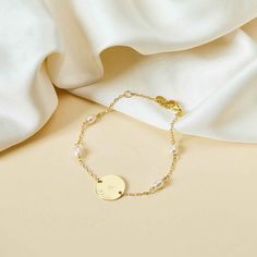 Perfect for all occasions, this personalized engraved Pearl Pastille Chain Bracelet features a delicate chain and freshwater pearls. Add a unique hand-engraved message on the front and reverse of the disc and create a sentimental keepsake, perfect for weddings, bridesmaid gifts or everyday wear.18K Champagne Gold Plated or 925 Sterling SilverBracelet measures 7, adjustable to 6.3Pastille Charm: 0.6 x 0.6Set with 4 freshwater pearlsEngraved by hand in our workshopSent with love from Paris in a co Elegant Engraved Name Bracelet For Bridesmaid, Elegant Name Bracelet With Engraving For Mother's Day, Elegant Hand Stamped Name Bracelet For Mother's Day, Personalized Gold Pearl Bracelet, Personalized Pearl Bracelet, Elegant Personalized Round Pearl Bracelet, Elegant Engraved Bracelets For Bridesmaid Gift, Elegant Personalized Pearl Bracelet For Wedding, Elegant Hand Stamped Name Bracelet For Anniversary