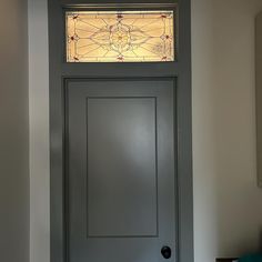 a door with a stained glass window above it