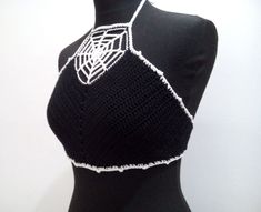 a mannequin wearing a black and white crochet halter top