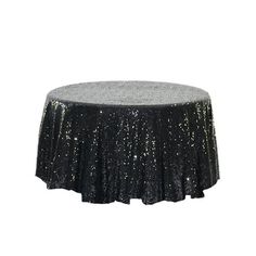 a black table cloth with silver sequins on it and a bottle of wine