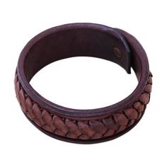 Designed by Thai artisan Khun Boom this striking bracelet circles the wrist with a wristband of dark brown leather. Khun Boom hand-weaves lighter brown leather strips around the exterior of the bracelet for a bold accessory. Brown Leather Strap Bracelet, Vintage Brown Cuff Bracelet With Wrist Strap, Brown Leather Braided Jewelry, Braided Brown Leather Jewelry, Brown Braided Leather Jewelry, Handmade Leather Braided Bracelet, Vintage Brown Bracelets With Bracelet Strap, Vintage Brown Bracelet With Strap, Brown Braided Leather Bracelets