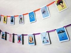 some cards are hanging from a string on the wall