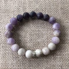 Add a dash of purple plus a boost of immunity with our 10 mm beaded ombre amethyst bracelet. Amethyst is known to aid sleep and enhance your immune system. And this gorgeous gem features all sorts of shades of amethyst in an ombre design with silver accents. This bracelet pairs well with our Deep Purple Amethyst Bracelet. Bracelets measure 6.25 inches around. But wrists come in different sizes, and so do our bracelets! If you want larger or smaller, simply specify when you order. Amethyst Natural Stones Beaded Bracelets For Meditation, Spiritual Lavender Crystal Bracelet For Meditation, Lavender Gemstone Beaded Bracelets For Meditation, Lavender 8mm Beads Jewelry For Healing, Lavender Natural Stone Beaded Bracelets For Meditation, Lavender Bracelets With Round Beads For Meditation, Healing Amethyst Beaded Bracelets, Lavender Round Beads Bracelets For Meditation, Lavender Beaded Bracelets With Natural Stones For Meditation