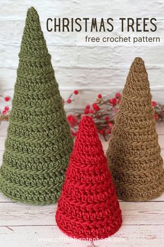 three crocheted christmas trees sitting next to each other