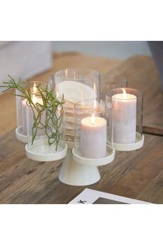 some candles are sitting on a wooden table