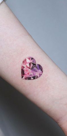 a heart shaped pink and purple diamond on the arm