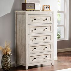 a white chest of drawers in a room