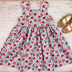 "Visit https://www.etsy.com/shop/ateliergaiana/?section_id=38140727 to check out other back to school dresses from AtelierGaiana! Your search for that unique and chic apple dress, farm dress, apple picking dress, picnic dress, harvest dress for your mini fashionista or a perfect fruit baby shower gift is over! Please meet Apple of my Eye \"Tina\" dress by AtelierGaiana! This girls dress, toddler dress, or baby dress with a full gathered skirt is sleeveless, it has an empire waistline and a squar Playful Cotton Dress For Picnic, Summer Cotton Dress With Fruit Print, Playful Cotton Dress With Fruit Print, Cute Sundress For Picnic, Cute Cotton Cherry Print Dresses, Cute Cotton Dresses With Cherry Print, Red Cotton Sundress For Garden Party, Cute Cherry Print Cotton Dress, Sleeveless Cotton Dress With Fruit Print