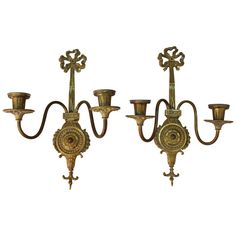 three antique brass wall sconces on white background