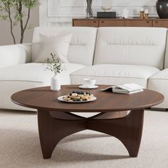 a living room with white couches and a coffee table in front of the couch