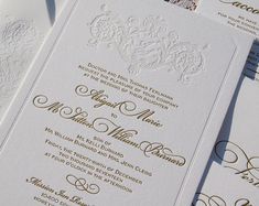 the wedding stationery is laid out on top of each other