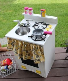 a toy stove sitting on top of a wooden table