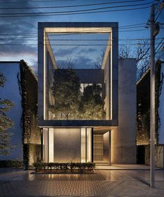 a modern house is lit up at night