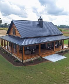 an aerial view of a house in the middle of a field