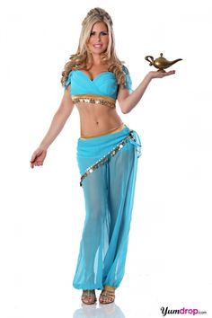 a woman in a belly dance outfit holding a bird