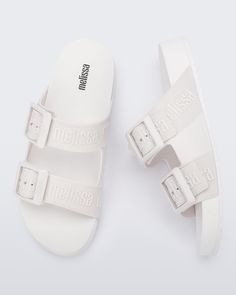 Stand out from the crowd with the Melissa Cozy Slide M-Lover, a sandal that and delivers unmatched style and fashion references thanks to the two wide buckle straps on the upper. The expanded PVC sole ensures maximum comfort and a lightweight feel. The slide is available in a variety of colorways.  Stylish slide. Two wide PVC Full Plastic buckle straps over the foot. Injected Comfy EVA outsole ensures maximum comfort and lightness. Extensive color selection. Inspired by the Logomania trend. Shor June Birthstone Jewelry, Cuff Watch, Gifts For New Mums, Pearl Jewellery Earrings, Cozy Chic, Evil Eye Jewelry, Eye Jewelry, Fine Jewelry Gift, June Birth Stone