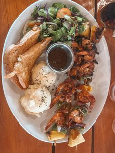 a white plate topped with meat and veggies