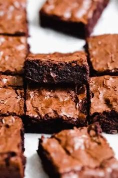 chocolate brownies cut into squares on a white surface