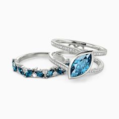 three rings with blue topazte and diamonds on each one, set in white gold