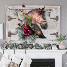 a fireplace mantel decorated with christmas decorations and stockings