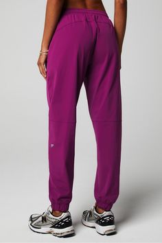 The One Jogger - Women's Fabletics purple female Activewear >> Womens >> Bottoms >> Pants & Joggers >> Joggers One regular Everyday Moisture-Wicking/Quick-Dry/UPF Protection/Zip Pockets Stretch Purple Gym Bottoms, Purple Stretch Bottoms For Gym, Purple Stretch Gym Bottoms, Purple Athleisure Pants For Gym, Purple Athleisure Pants For Workout, Sporty Purple Workout Pants, Purple Athleisure Workout Pants, Purple Activewear With Elastic Waistband For Sports, Purple Activewear With Elastic Waistband