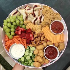 a platter filled with finger foods and fruit