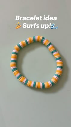 an orange, yellow and blue bracelet with words that read bracelet idea surfs up