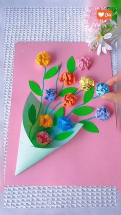 someone is making a flower bouquet out of paper