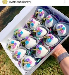 a box filled with white and pink heart shaped cakes