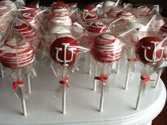 red and white cake pops with the letter j on them are ready to be eaten