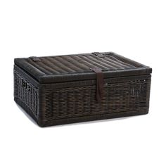 a brown wicker basket with leather handles on a white background for use as a storage container