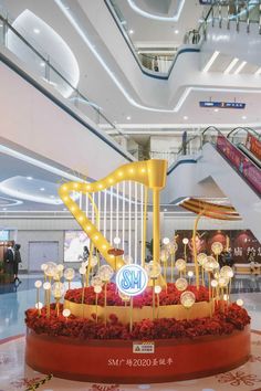 the interior of a shopping mall decorated with lights and decorations for music instruments on display