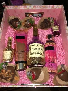 a pink box filled with lots of different types of liquor and confection items