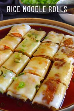 rice noodle rolls in a bowl with sauce and green onions on the side, ready to be eaten